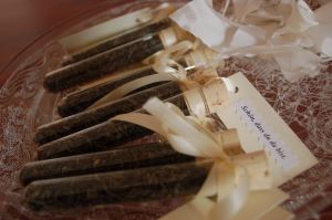 Test tubes in a bowl, with white bows and a note reading "Nice to have you".